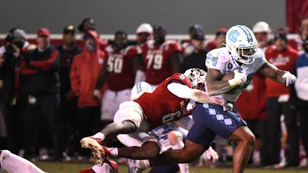 Nov 26, 2021; Raleigh, North Carolina, USA; North Carolina Tar Heels running back British Brooks (24) runs the ball during the second half against the North Carolina State Wolfpack at Carter-Finley Stadium. The Wolfpack won 34-30. Mandatory Credit: Rob Kinnan-USA TODAY Sports